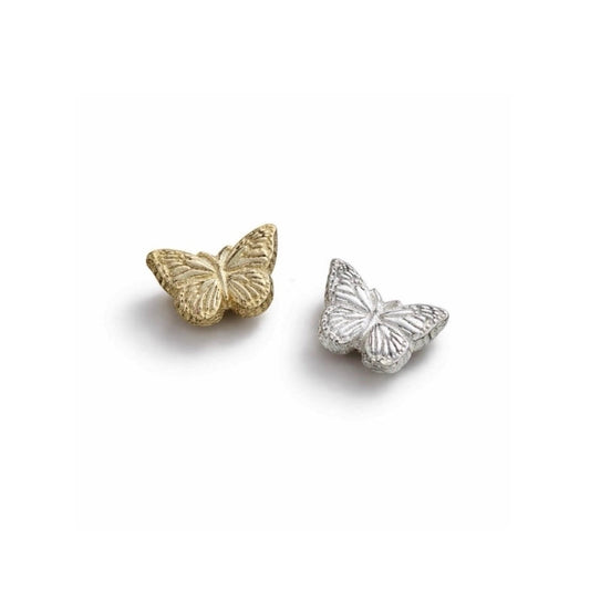 Gold and silver butterfly-shaped charms on a white background